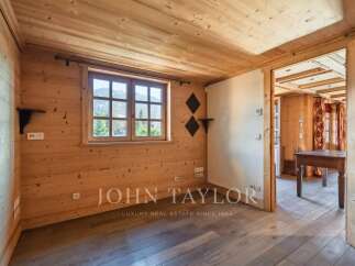 Step into this inviting space, showcasing a warm wooden interior and a bright window offering scenic views.