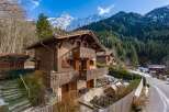 Nestled in a picturesque mountain setting, this charming wooden chalet offers a tranquil retreat.