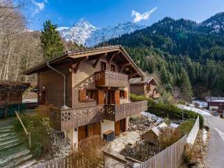 Nestled in a picturesque mountain setting, this charming wooden chalet offers a tranquil retreat.