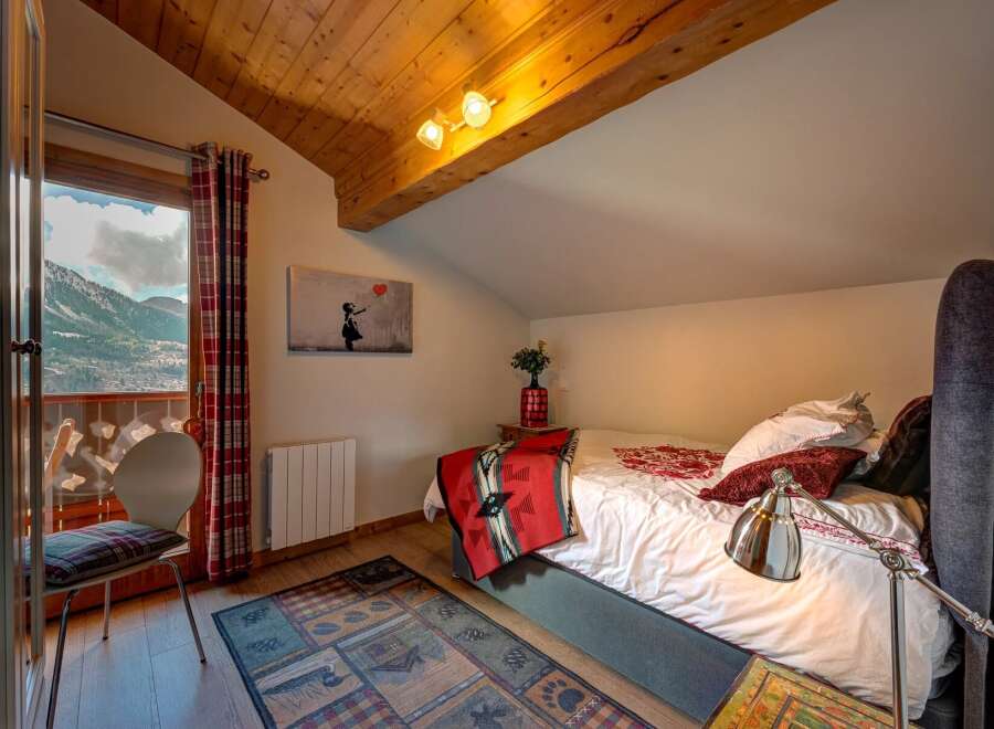 Experience the charm of this cozy bedroom with stunning mountain views.
