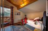 Experience the charm of this cozy bedroom with stunning mountain views.