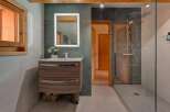 Step into this beautifully designed bathroom, featuring a modern vanity with ample storage and a sleek, illuminated mirror.