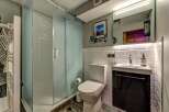 Step into this modern bathroom, featuring a sleek glass shower enclosure and stylish subway tile accents.