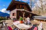 Escape to this stunning wooden chalet nestled in a picturesque mountain setting.