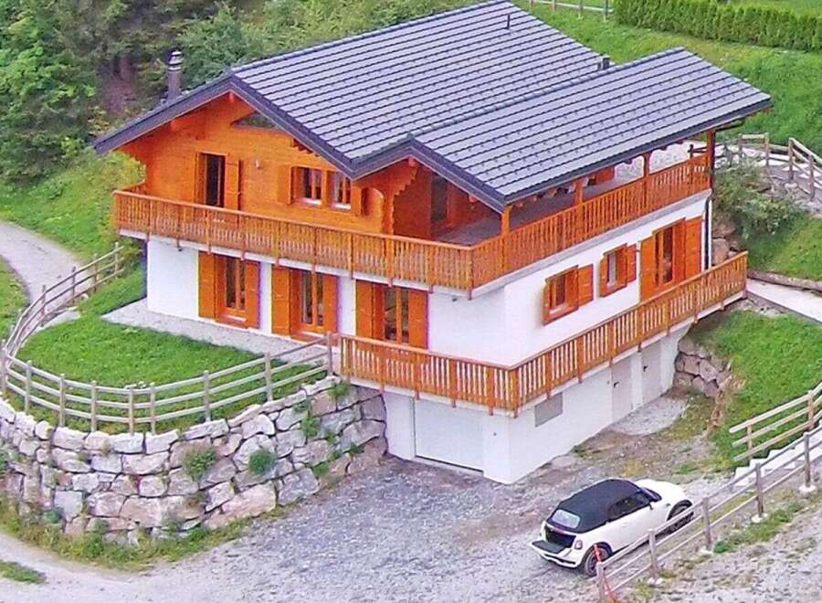 This stunning chalet-style home offers a perfect blend of rustic charm and modern comfort.