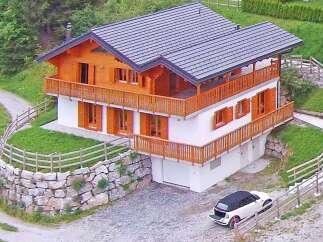 This stunning chalet-style home offers a perfect blend of rustic charm and modern comfort.