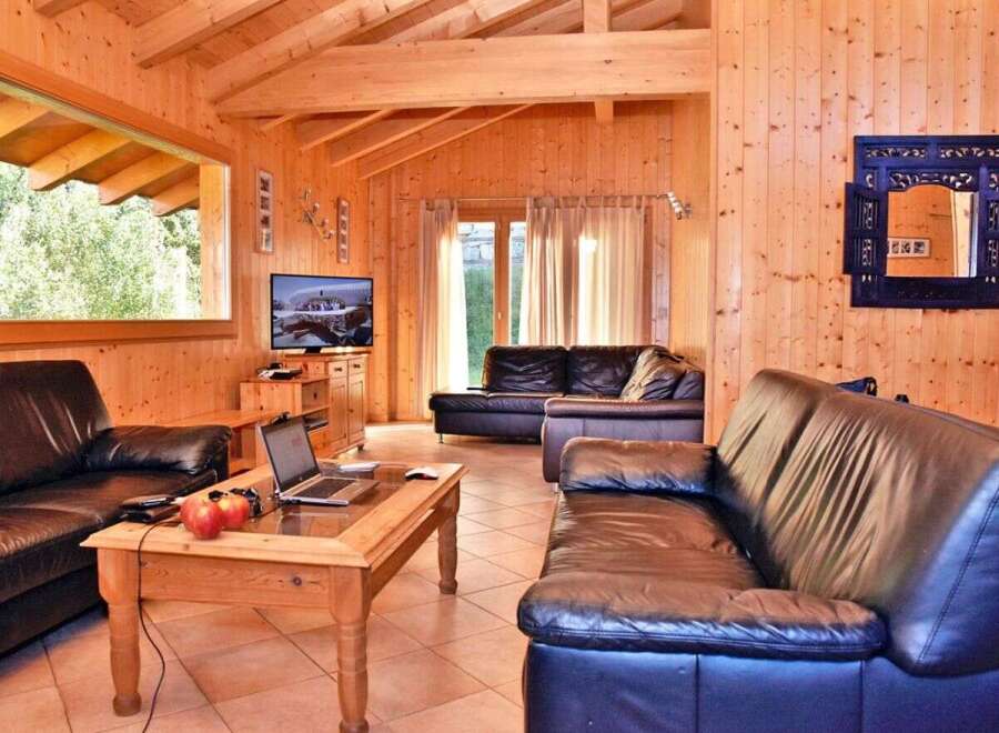Step into this inviting living space, featuring warm wooden paneling and a cozy atmosphere.