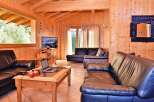 Step into this inviting living space, featuring warm wooden paneling and a cozy atmosphere.