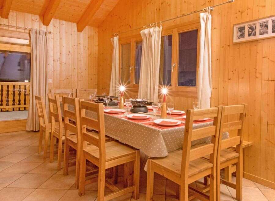 This charming dining area features a warm, inviting atmosphere, perfect for family gatherings or intimate dinners.