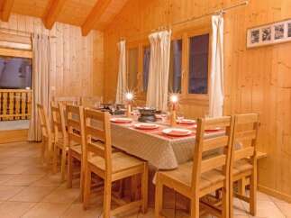 This charming dining area features a warm, inviting atmosphere, perfect for family gatherings or intimate dinners.