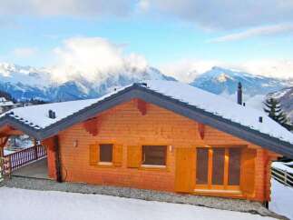 Discover the charm of this stunning wooden chalet nestled in a picturesque mountain setting.