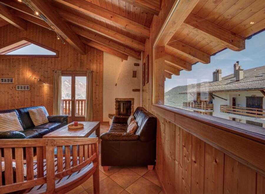 Experience rustic charm and breathtaking mountain views from this cozy living room.