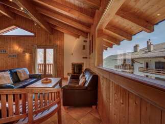 Experience rustic charm and breathtaking mountain views from this cozy living room.
