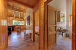Experience rustic charm in this beautifully appointed wooden cabin, featuring a spacious living area with comfortable seating and a large window offering scenic views.