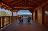 Enjoy breathtaking mountain views from this charming wooden balcony, perfect for al fresco dining or morning coffee.