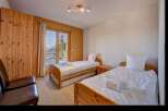 This charming bedroom features two twin beds, perfect for accommodating guests or family.