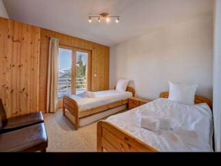 This charming bedroom features two twin beds, perfect for accommodating guests or family.
