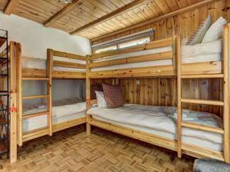 This cozy bunk room offers a unique and inviting space for guests.