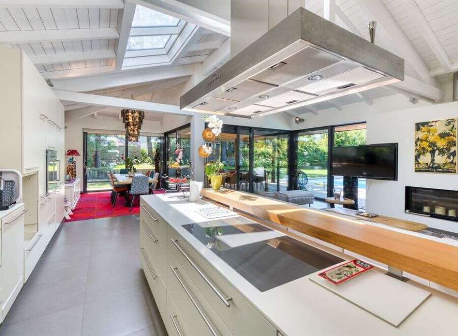 This stunning kitchen boasts a modern design with sleek cabinetry and high-end appliances.