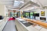 This stunning kitchen boasts a modern design with sleek cabinetry and high-end appliances.