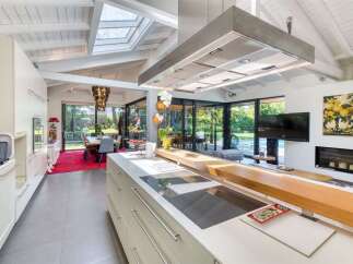This stunning kitchen boasts a modern design with sleek cabinetry and high-end appliances.