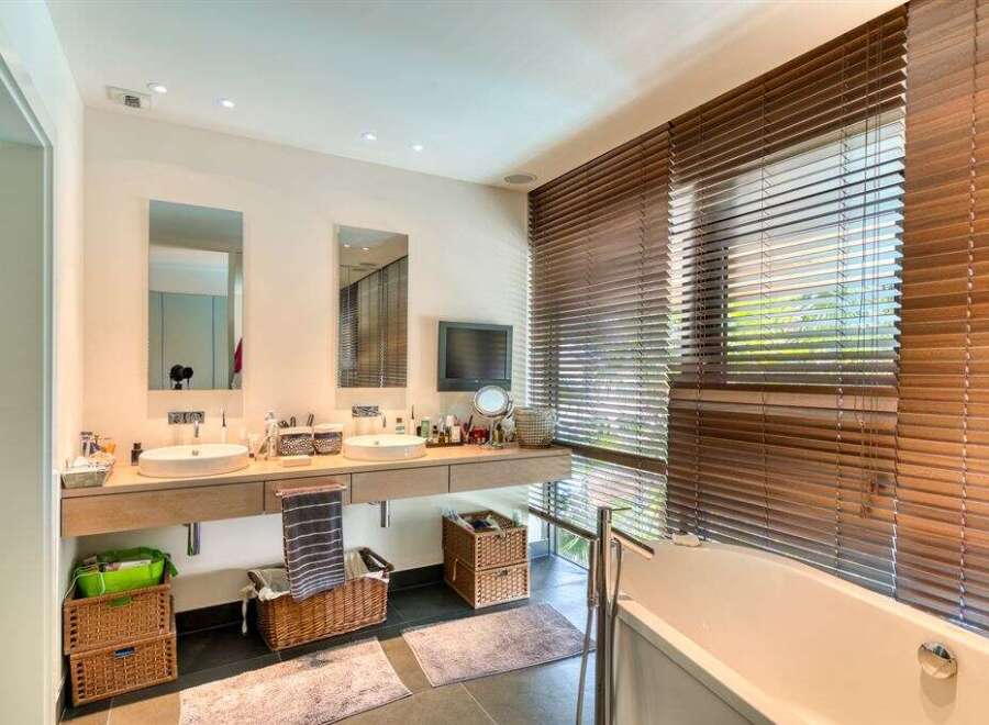 This luxurious bathroom boasts a sleek design with modern fixtures and ample space.