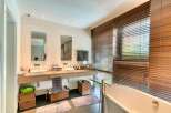 This luxurious bathroom boasts a sleek design with modern fixtures and ample space.