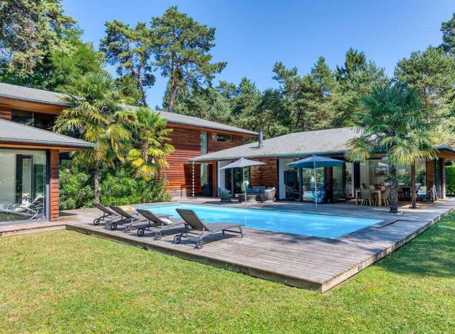 Discover your dream home in this stunning property featuring a private pool and expansive wooden deck, perfect for relaxation and entertaining.