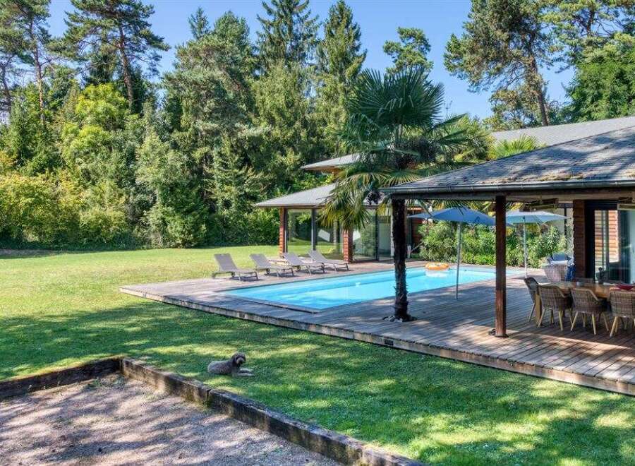 Discover your dream home with this stunning property featuring a private pool and lush green surroundings.