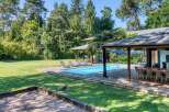 Discover your dream home with this stunning property featuring a private pool and lush green surroundings.