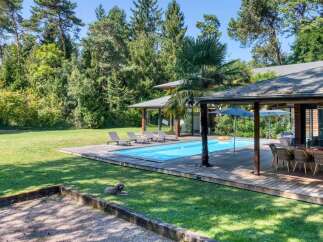 Discover your dream home with this stunning property featuring a private pool and lush green surroundings.