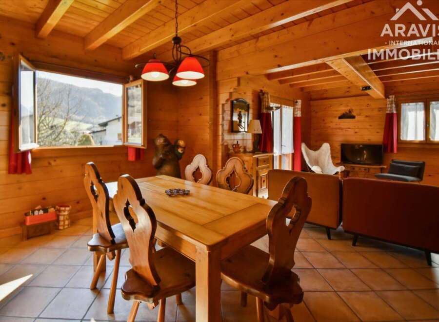Step into this charming chalet, boasting a warm and inviting interior with wooden walls and ceilings.