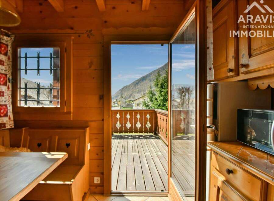 Discover the charm of this cozy property, featuring a warm wooden interior and a stunning view.