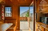 Discover the charm of this cozy property, featuring a warm wooden interior and a stunning view.