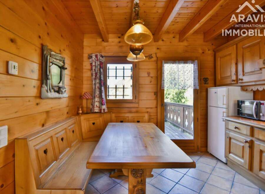 This charming property features a cozy wooden interior, creating a warm and inviting atmosphere.