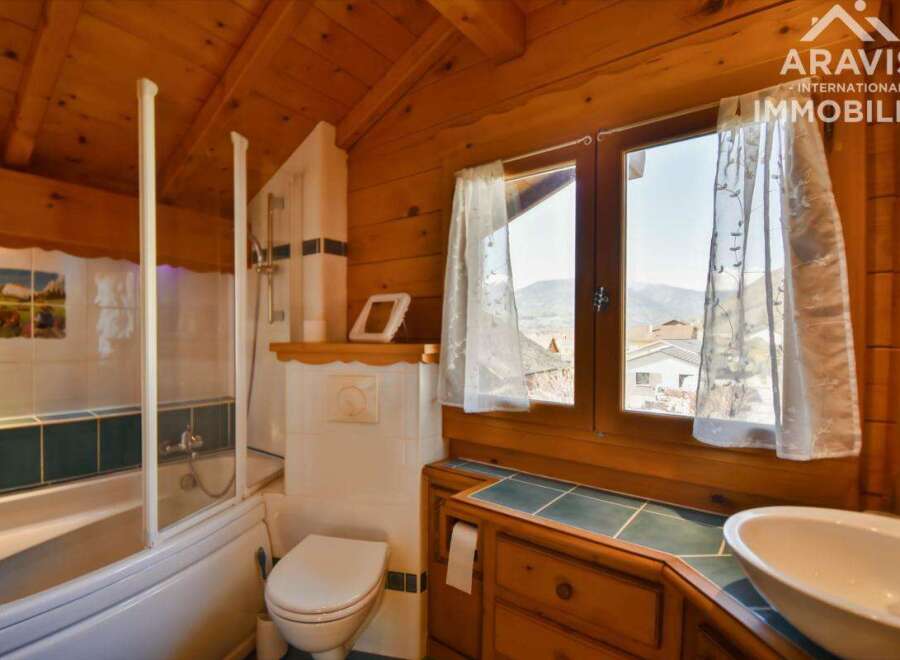 Discover the charm of this cozy bathroom, featuring a unique wooden design that exudes warmth and character.