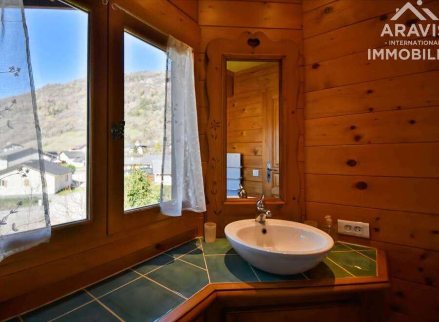 This charming property boasts a cozy bathroom with a unique wooden interior, creating a warm and inviting atmosphere.