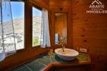This charming property boasts a cozy bathroom with a unique wooden interior, creating a warm and inviting atmosphere.