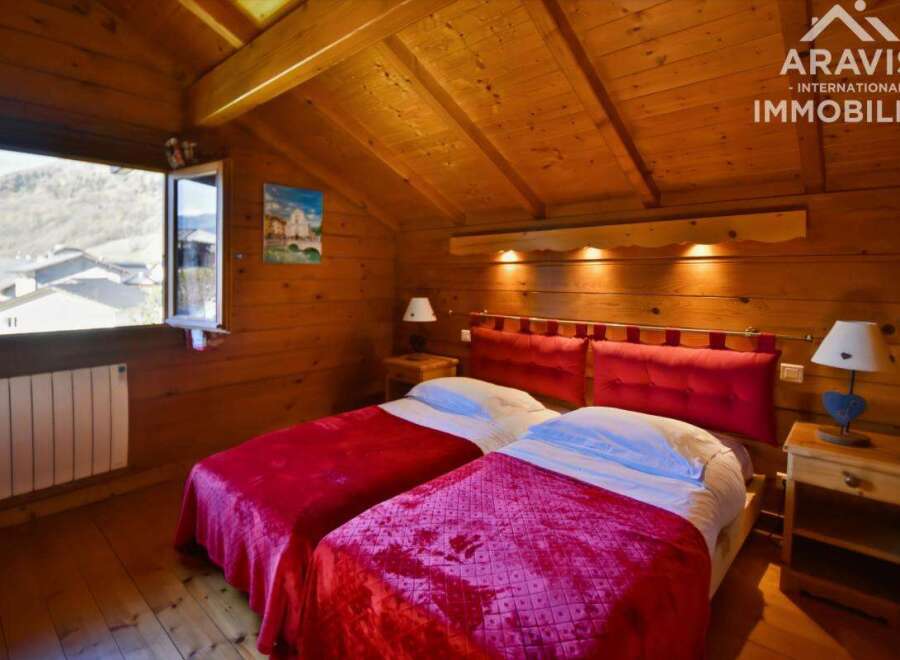Discover the charm of this cozy bedroom featuring warm wooden accents and a comfortable double bed.