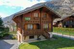 Discover the charm of this stunning wooden chalet nestled in a picturesque mountain setting.