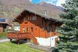 This charming wooden chalet offers a cozy retreat with stunning mountain views.