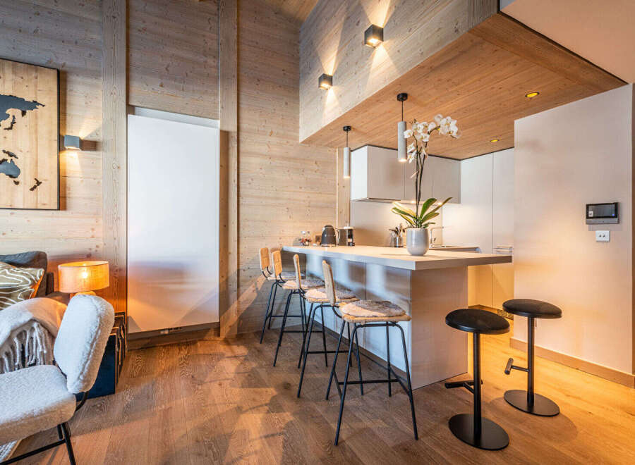 Experience modern luxury in this stunning property featuring a stylish kitchen with a breakfast bar and sleek appliances.