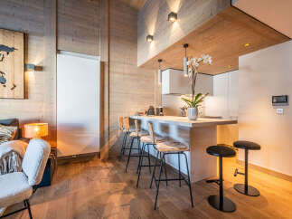 Experience modern luxury in this stunning property featuring a stylish kitchen with a breakfast bar and sleek appliances.