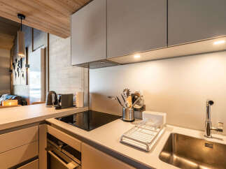 Discover modern living in this stylish kitchen! Featuring sleek cabinetry, a built-in cooktop, and a stainless steel sink, this space is perfect for culinary enthusiasts.