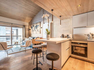 Experience luxury living in this stunning property, featuring a modern kitchen with sleek countertops and high-end appliances.