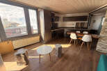 Experience the charm of this modern apartment, featuring a well-equipped kitchen and a cozy dining area perfect for gatherings.