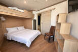 Discover this cozy and stylish bedroom featuring a unique bunk bed design, perfect for maximizing space.