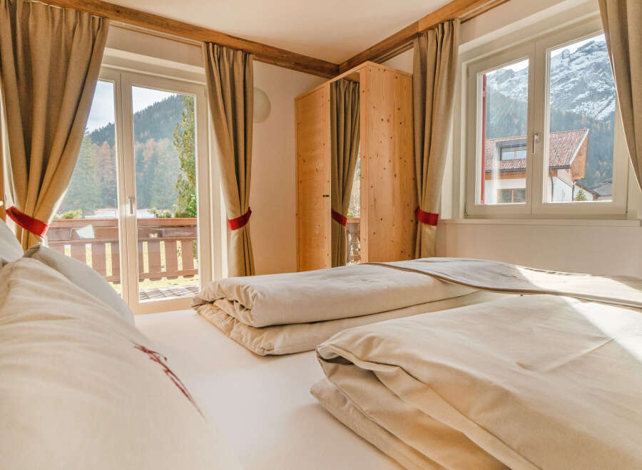 Experience the tranquility of this cozy bedroom, featuring a comfortable bed and stunning views.