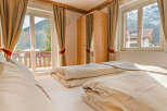 Experience the tranquility of this cozy bedroom, featuring a comfortable bed and stunning views.
