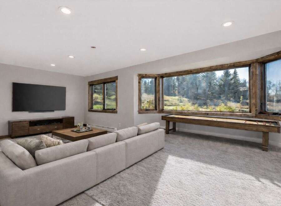 Experience luxury living in this stunning property! This home boasts a spacious living area with a large TV and a comfortable sofa, perfect for relaxation.